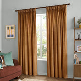Caramel velvet pencil pleat curtains hanging from a dark rod, dressing a living room window with soft folds falling to the floor.