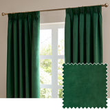 Emerald green velvet pencil pleat curtains with pinch-pleat heading hung on a brass pole in front of a window, shown beside a matching fabric swatch.