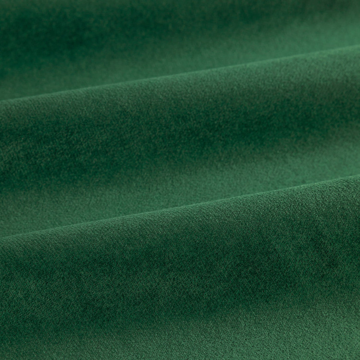 Close-up of The Ultimate Velvet Polyester Pencil Pleat Curtains in emerald green, showing soft matt velvet fabric with gentle folds.