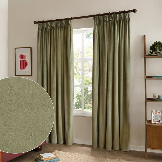 Green velvet pencil pleat curtains with pinch-pleated heading on a dark rod, shown hanging beside a window in a living room, with a fabric swatch inset.
