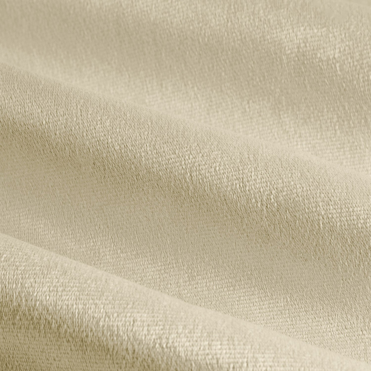 Close-up of The Ultimate Velvet Pencil Pleat Curtains in natural, showing soft matt velvet fabric with visible woven texture, draped in folds.
