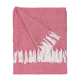 Dessa Geometric Polyester Throw in fuchsia, folded flat with a small diamond pattern on a pink-red ground and knotted off-white fringe, shown on a white background.