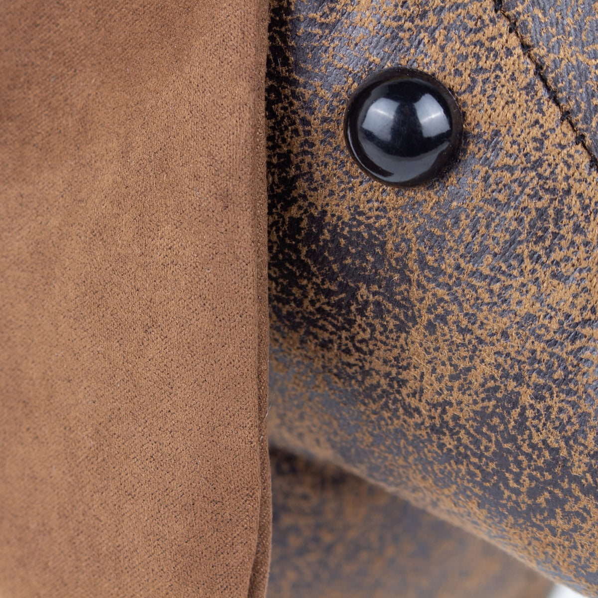 Close-up of the Dexter dachshund door stop showing mottled brown faux leather body texture, a glossy black beaded eye, and a soft tan faux suede ear.