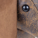 Close-up of the Dexter dachshund door stop showing mottled brown faux leather body texture, a glossy black beaded eye, and a soft tan faux suede ear.