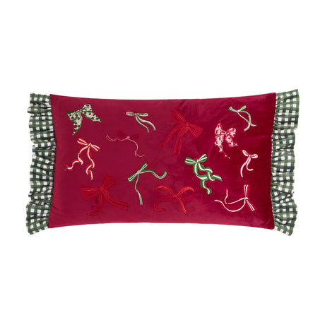 Ditsy Bows rectangular velvet cushion in deep red with embroidered bow designs in red, green and cream, edged with green and white gingham ruffles, shown on a white background.