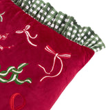 Ditsy Bows Gingham Velvet Cushion in deep red velvet with embroidered bows in red, green, cream and white, edged with a green and white gingham ruffle, shown on a white background.