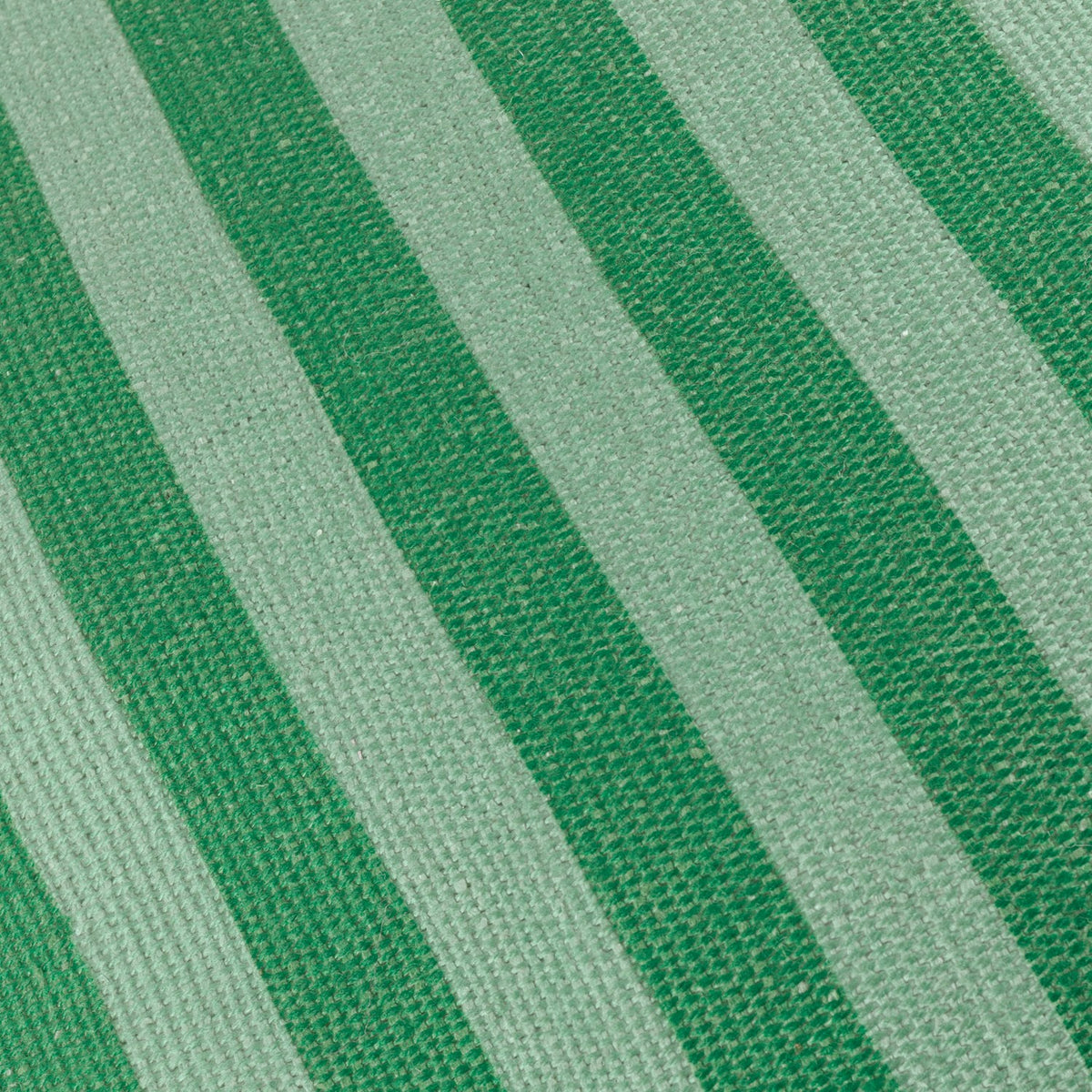 Close-up of the Deck Stripe reversible polyester cushion in green, showing broad woven vertical bands of deep bottle green and soft sage.