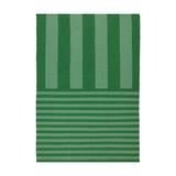 Deck Stripe Printed Polyester Rug in green, flatweave design with bold vertical stripes shifting to narrower horizontal lines at one end, shown on a plain white background.