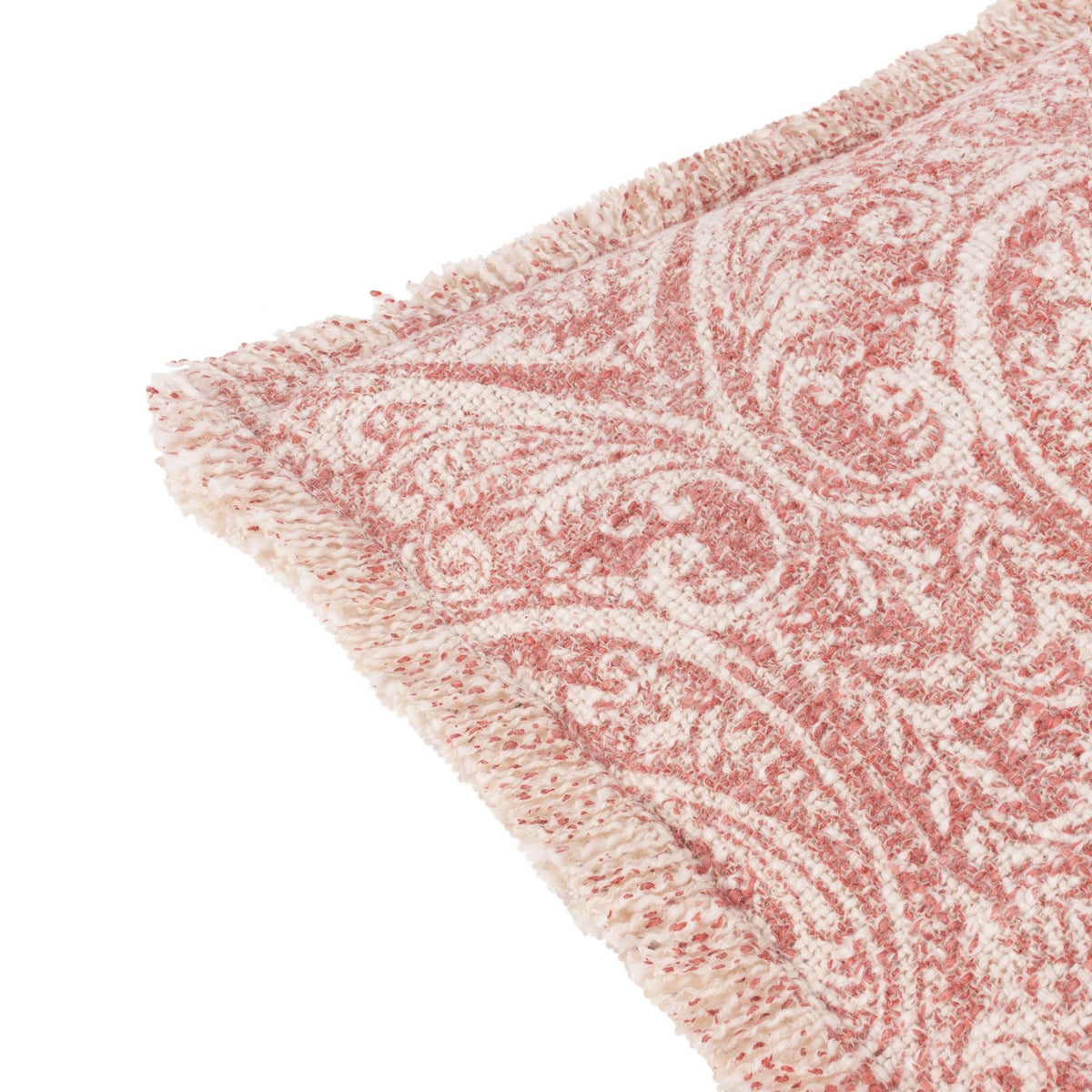 Durelle Damask Cotton Cushion in coral, close-up of the frayed edge and scrolling foliate pattern in coral-pink on a cream slub cotton ground, shown on a white background.