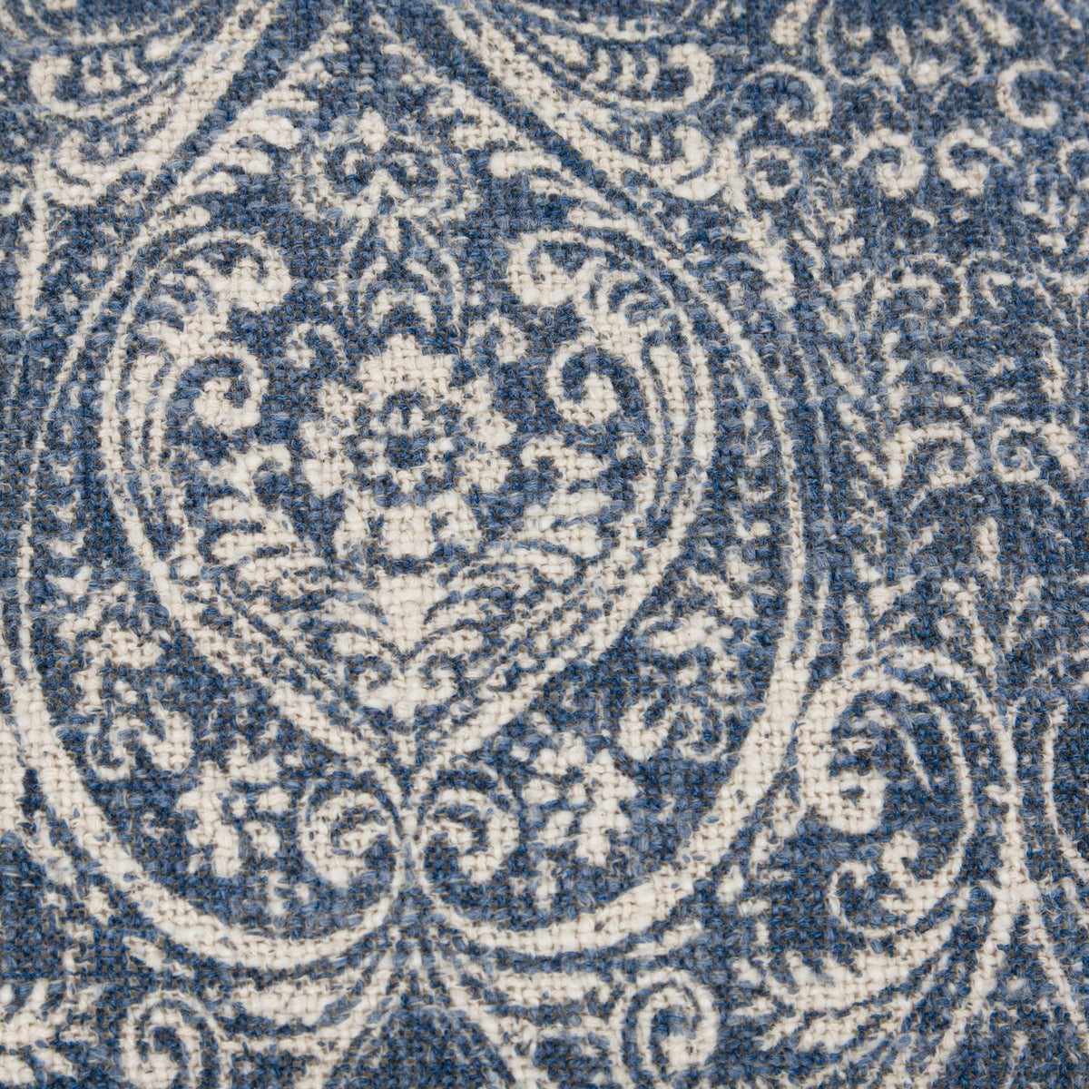 Close-up of the Durelle Damask Cotton Cushion in Delph Blue, showing a scrolling medallion and floral damask pattern printed in deep blue on cream slub cotton.