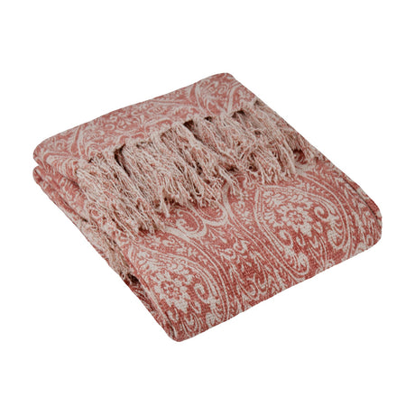 Durelle Damask Cotton Throw in coral pink, folded to show a paisley and floral pattern on cream cotton with knotted tassel fringe, on a plain white background.