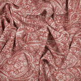 Durelle Damask Cotton Throw in coral, showing a draped paisley and floral pattern in coral pink on cream cotton fabric.