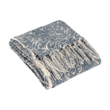 Durelle Damask Cotton Throw in Delph Blue, folded to show its ivory-cream scrolling damask pattern and knotted fringe edge, on a plain white background.