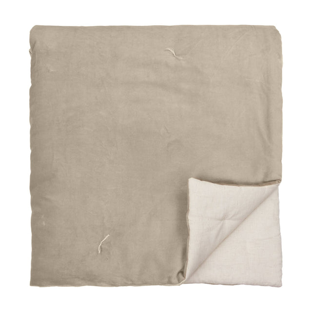 Edie Linen Cotton Bedspread in natural, folded to show soft velvet-finish top and linen-look cotton reverse, on a plain white background.