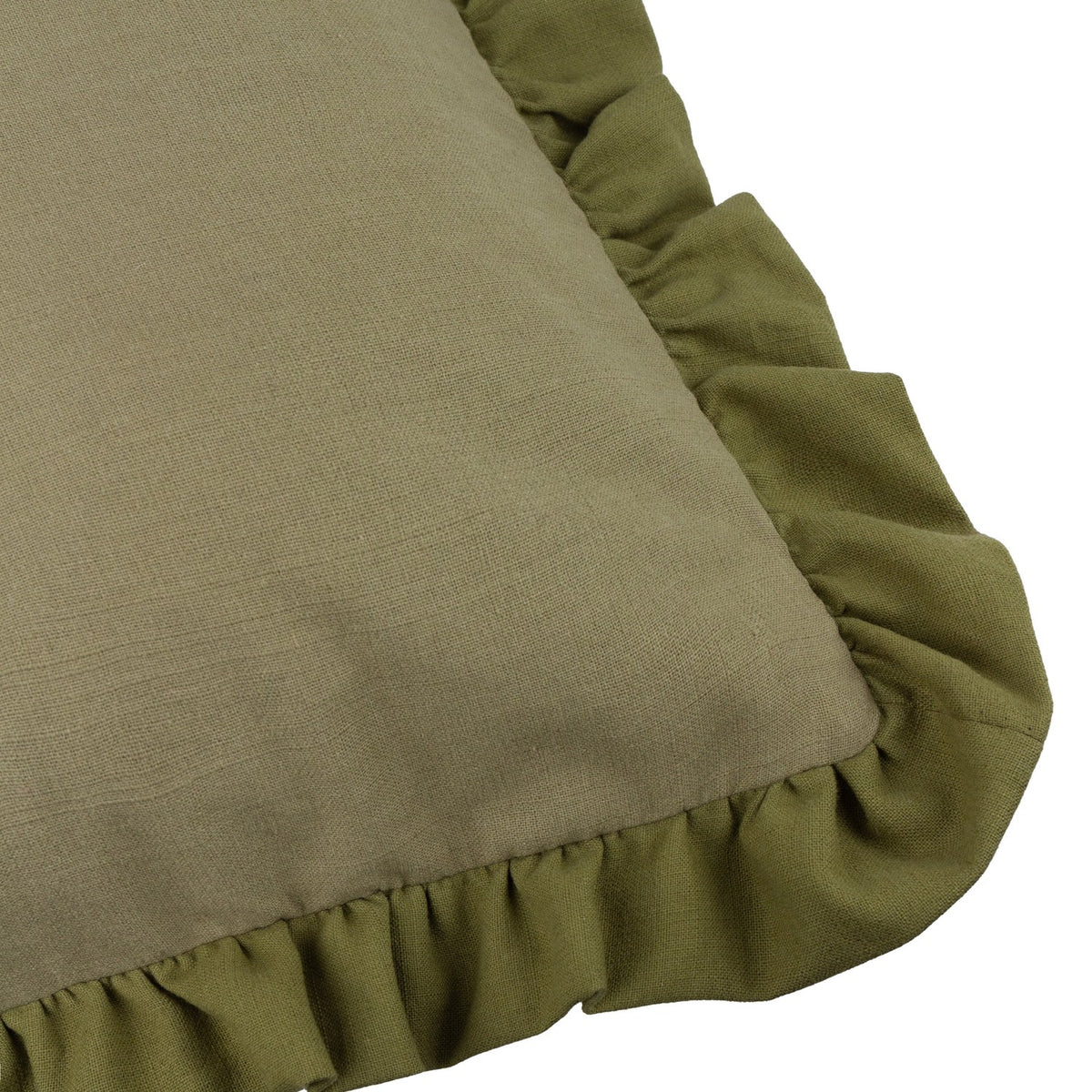 Close-up of the Effie Plain Cotton Cushion in sage green, showing the slub cotton texture and gathered ruffle trim edge on a white background.