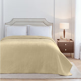 Elara Embroidered Cotton Plain Duvet Cover Set in champagne on a bed with white pillowcases, quilted throw and upholstered headboard in a bedroom setting.