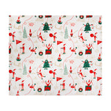 Elfie Printed Polyester Throw in cream, featuring a festive pattern of elves skiing, decorating trees, Nice List flags and North Pole signs in red and green.
