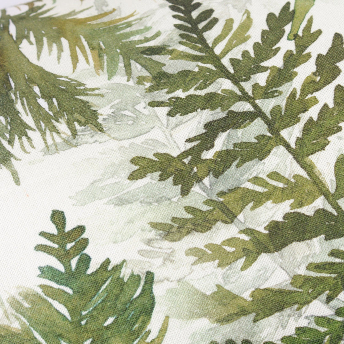 Close-up of the Elowen Linen Cotton Cushion in Moss, showing a hand-painted watercolour fern and foliage design in moss green and earthy tones on a cream linen-cotton ground.