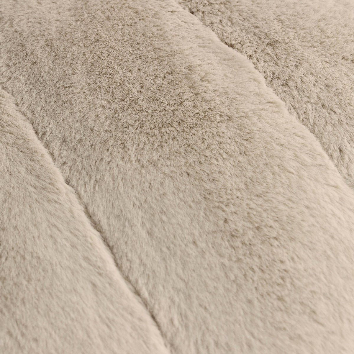 Close-up of the Empress Plain Faux Fur Cushion in oatmeal, showing deep plush pile with vertical ribbed channels across the surface.