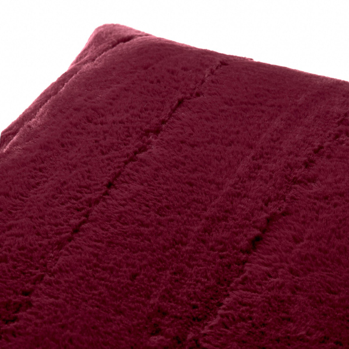 Close-up of the Empress Velvet Faux Fur Cushion in ruby-red, showing soft long-pile fabric with vertical stitched channels, photographed against a plain white background.