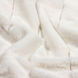 Close-up of the Empress Velvet Faux Fur Throw in cream, showing deep, long-piled fabric in soft ribbed vertical channels with a folded, textured surface.