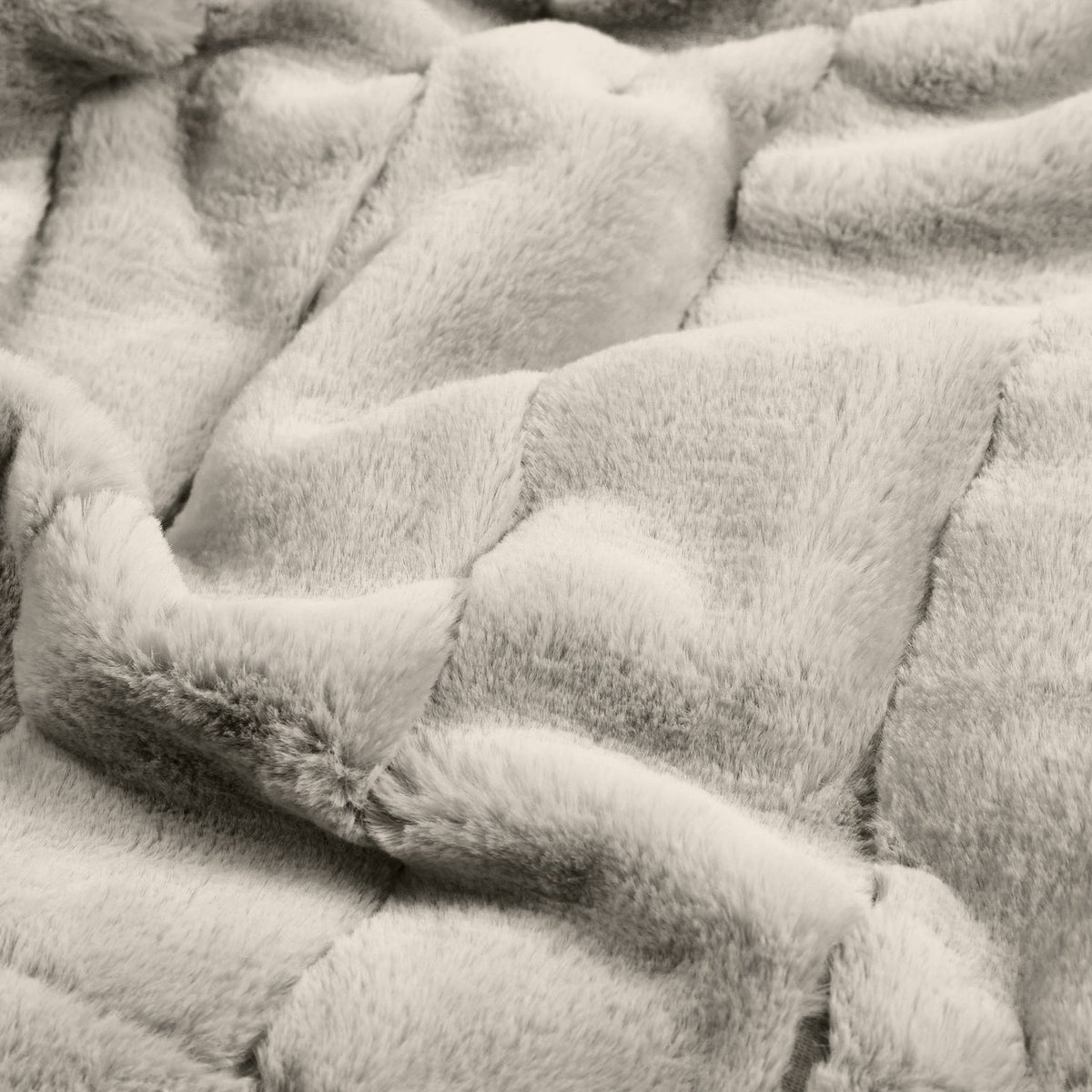 Close-up of the Empress Velvet Faux Fur Throw in grey, showing its deep, long-pile texture brushed into soft, channelled folds with a plush, pelt-like finish.
