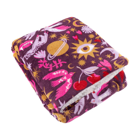 Enchanted Printed Polyester Throw folded to show its plum ground with pink, lilac, gold and red mystical print, sherpa fleece reverse visible, on a plain white background.