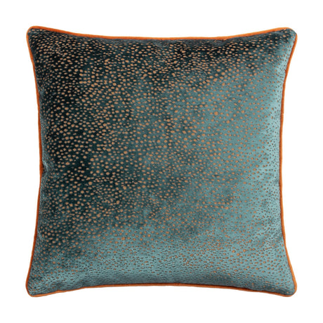 Estelle Reversible Velvet Cushion in teal with amber-rust spotted pattern and contrasting orange piped edge, shown on a plain white background.
