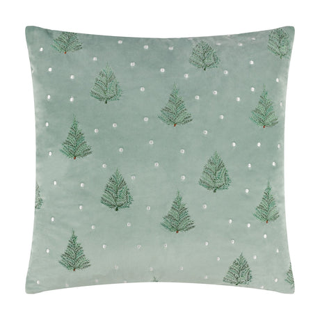 Square mint green velvet cushion with embroidered fir trees and scattered white dots, shown on a plain white background.