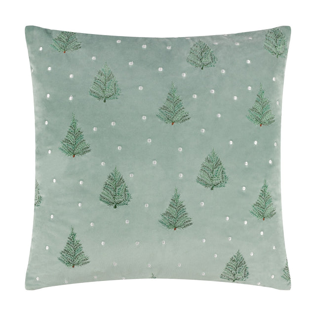 Square mint green velvet cushion with embroidered fir trees and scattered white dots, shown on a plain white background.