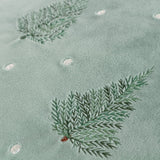 Close-up of the Evergreen Velvet Cotton Cushion in mint green, showing embroidered fir tree branches in shaded greens with small pale dot detailing on the velvet face.