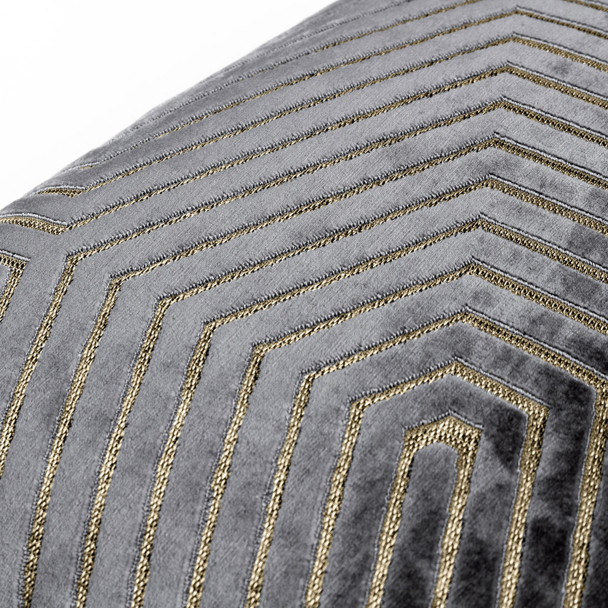 Close-up of the Evoke Geometric Velvet Cushion in charcoal grey, showing cut velvet hexagonal lines with metallic gold thread detailing.