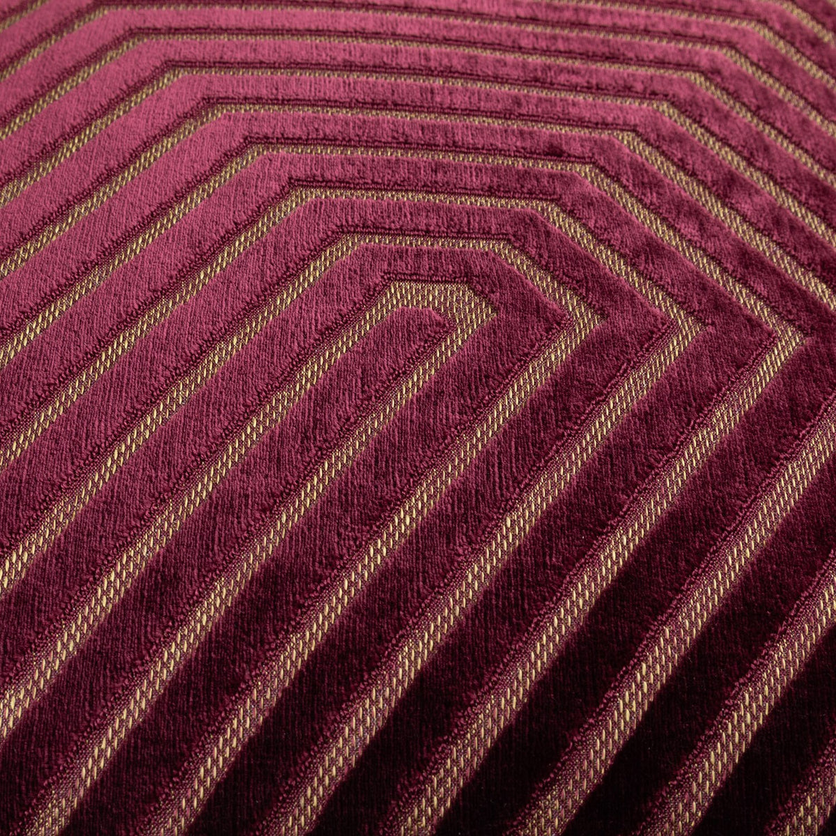 Close-up of the Evoke Geometric Velvet Cushion in burgundy, showing raised chevron patterning with slim gold-toned contrast threads woven through the pile.
