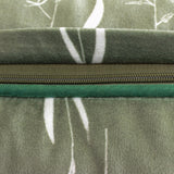 Close-up of the Fearne Reversible Velvet Cushion's zip closure, showing sage green botanical-print velvet on one side and plain emerald green velvet on the reverse.