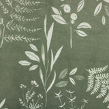 Close-up of the Fearne Reversible Velvet Cushion in sage green, showing a hand-drawn white botanical print of ferns, berries and grasses on a mottled velvet ground.