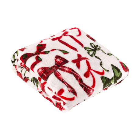 Nathaliefestivebows Bows Polyester Throw folded on a white background, cream fleece with a printed bow design in berry red, pine green, and red tartan check.