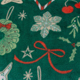 Festive Treats Printed Polyester Throw in emerald green, close-up of fleece fabric showing snowflakes, a wreath, star motifs and red ribbon bows on a deep green ground.