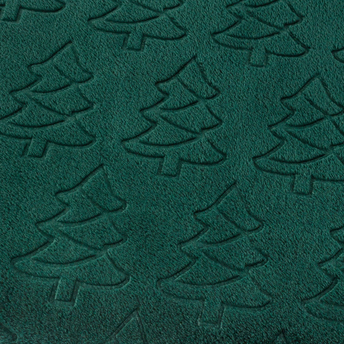 Close-up of the Festive Trees Woodland Polyester Throw in emerald green, showing an embossed Christmas tree pattern raised from the soft fleece pile.