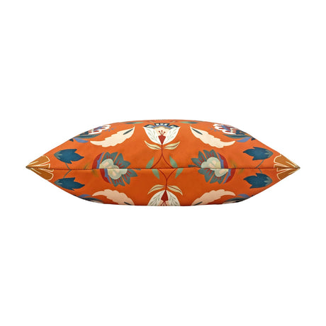 Folk Flora Floral Polyester Cushion in orange, shown edge-on to reveal the bolster-like shape with symmetrical folk-art blooms in blue, teal, cream and red, against a plain white background.