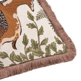 Corner detail of the Fable Fox and Deer Woodland Cotton Cushion, showing woven fox and foliage design on cream cotton with dusky-pink fringe trim.
