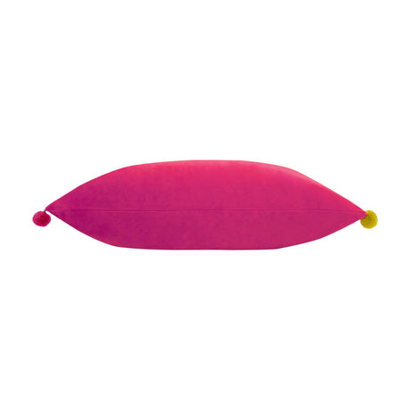 Fiesta Plain Velvet Cushion in hot pink, shown lengthwise with a pompom in a contrasting colour at each pointed end, on a plain white background.
