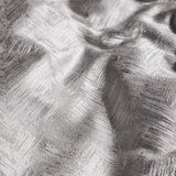 Close-up of the Folius Cotton Leaf Duvet Cover Set in silver, showing a jacquard woven leaf pattern with a raised, feathered texture on draped fabric.