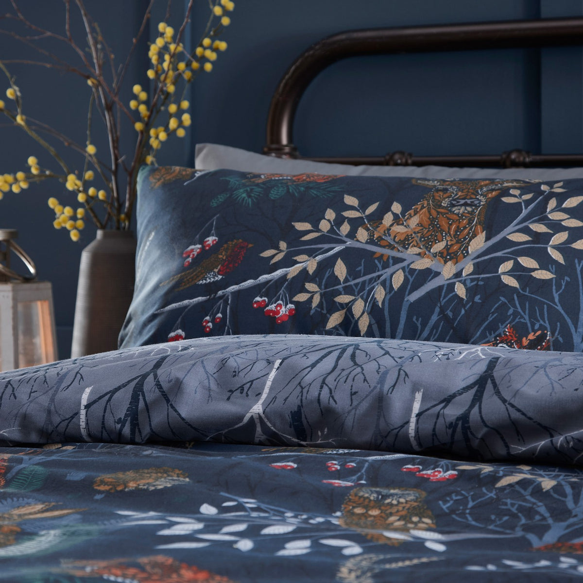 Forest Fauna Woodland Animal Duvet Cover Set in navy, shown on a bed with a printed forest scene of birds, branches and berries, paired with a matching pillowcase.