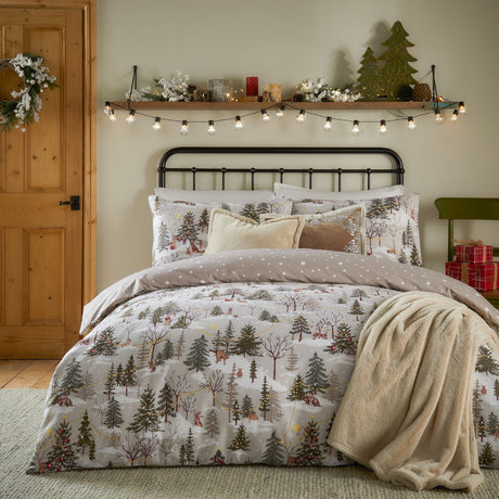 Forest Festivities Cotton Spotted Duvet Cover Set in Natural on a bed with matching pillowshams, styled in a bedroom with a festive shelf, fairy lights and a cream throw.