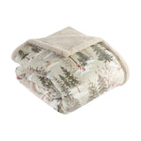 Forest Festivities Velvet Faux Fur Throw in natural, folded to show the printed winter woodland velvet face with trees and animals against the cream faux fur reverse, on a white background.