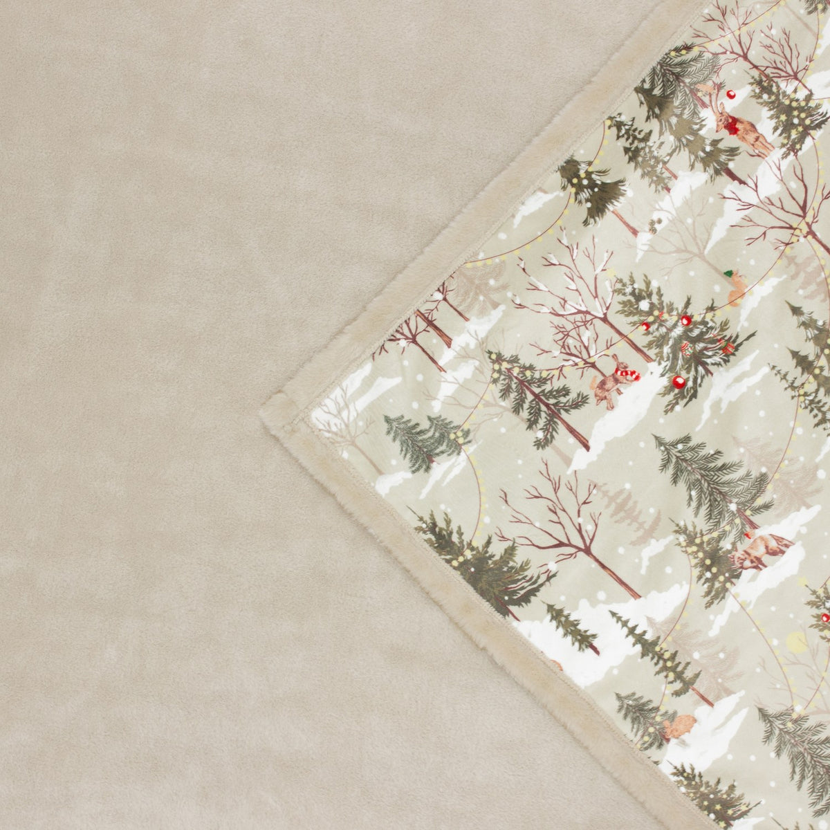 Forest Festivities Velvet Faux Fur Throw in Natural, folded corner showing printed winter woodland scene with trees and animals against cream faux fur reverse.