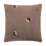 Square faux fur cushion in mocha brown, embroidered with Christmas pudding motifs and holly sprigs, shown on a plain white background.