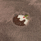 Close-up of the Festive Puddings Embroidered Faux Fur Cushion in mocha, showing a raised embroidered Christmas pudding with holly on plush brown faux fur.