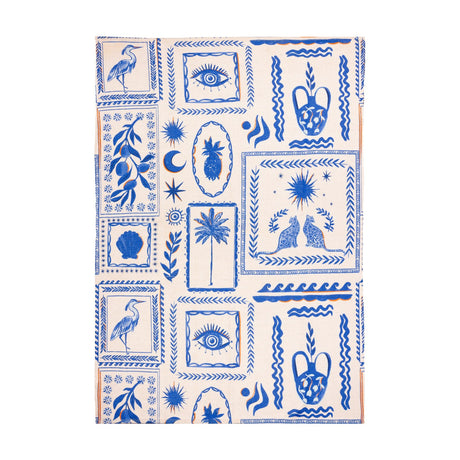 Frieze Abstract Polyester Rug in blue and cream, featuring folk-art panels of herons, palms, pineapples, a shell, seated cats, an eye motif and waves, shown flat on a white background.