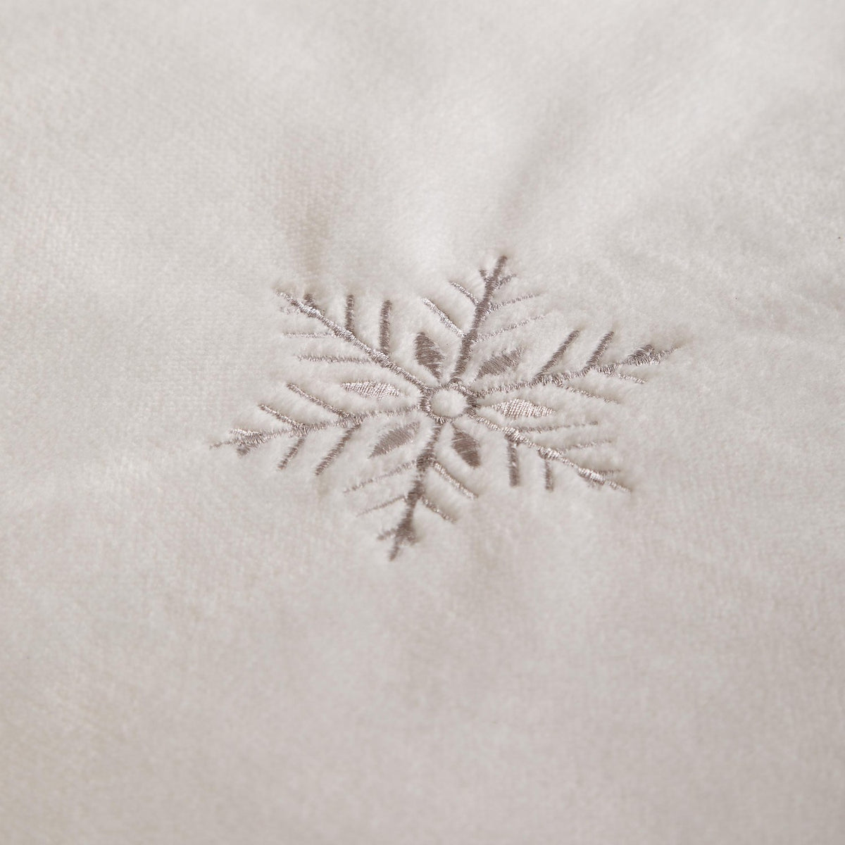 Close-up of the Frosted Snowflake Polyester Embroidered Duvet Cover Set in white, showing a silver-grey embroidered snowflake on soft brushed flannel fleece fabric.
